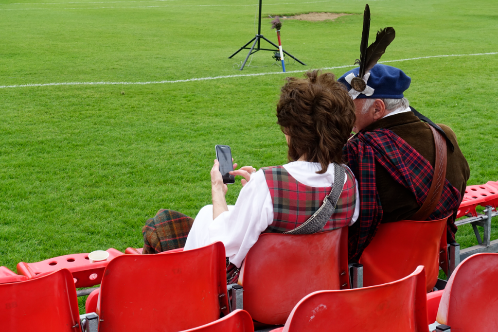 Two people in tartan look at a phone